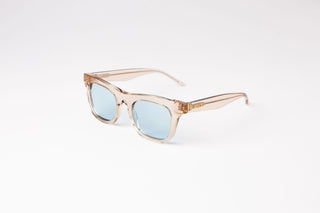 angle view of peach clear biodegradable and sustainable ike oat clue sunglasses with blue lens